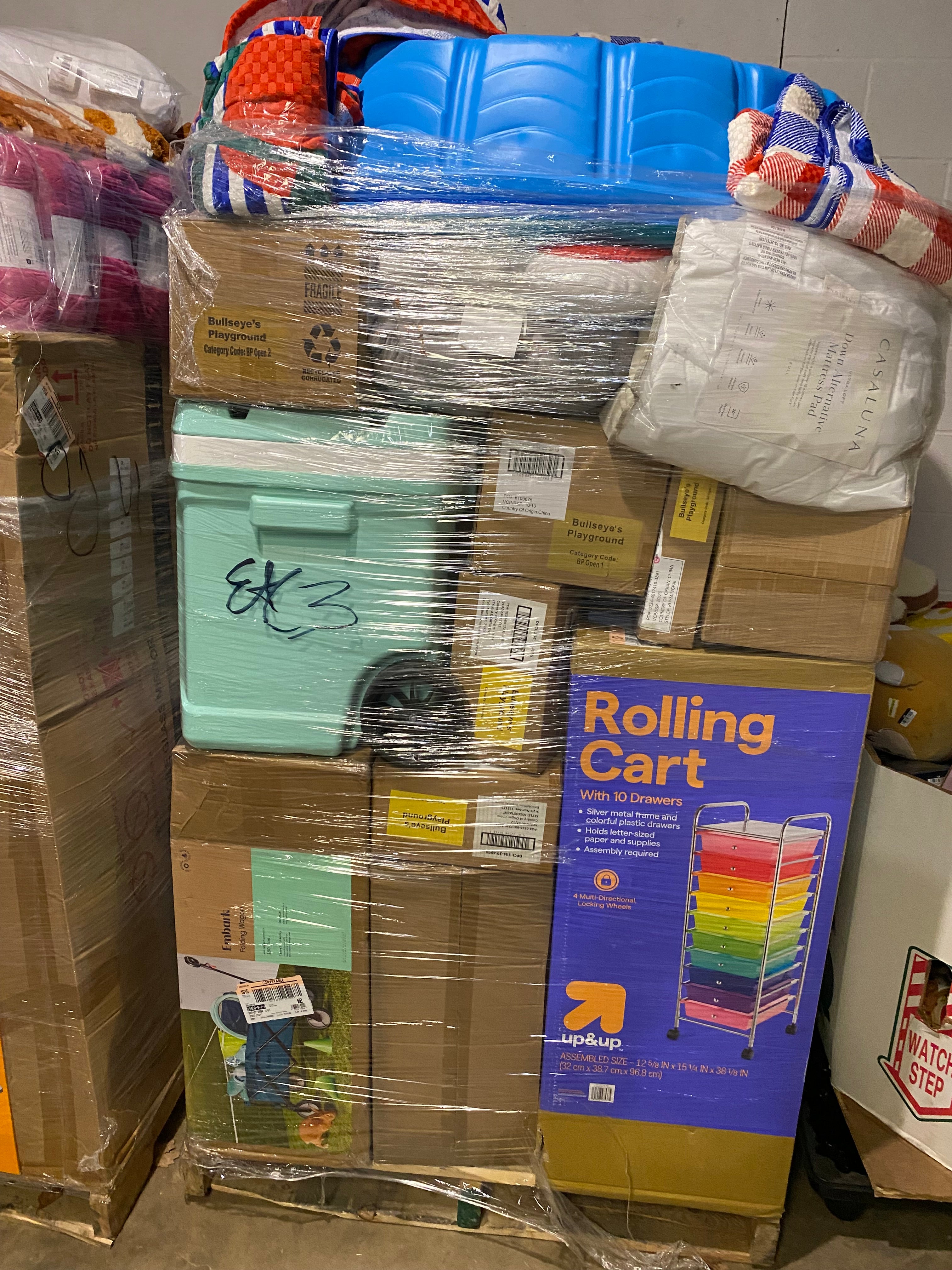 Target general merchandise pallet stacked and wrapped with assorted household goods, home essentials, and mixed retail items for resale and liquidation buyers